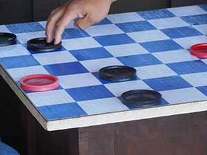 Checkers game board with checkers on it