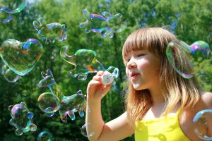 Toddler blowing bubbles